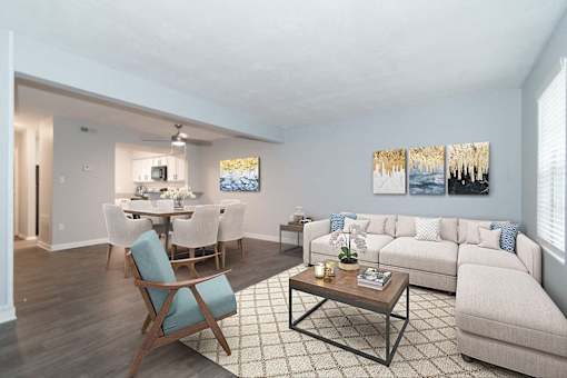 A living room with a dining table and chairs.