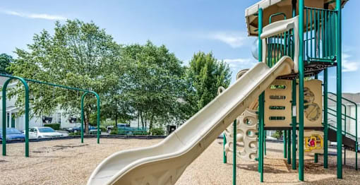 A playground with a slide and a climbing structure.