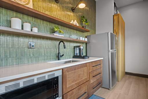 A kitchen with a black oven and a black fridge.