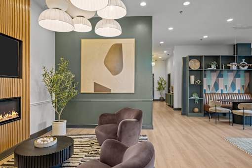 A modern living room with a fireplace and a large abstract painting on the wall.