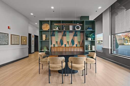 A modern dining room with a long table and chairs.