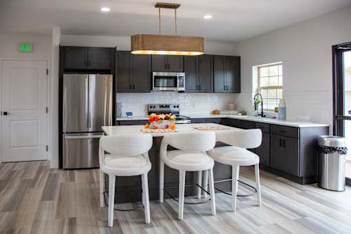 A kitchen with a white table and chairs at Evergreen Luxury Apartments, Merrillville, Indiana