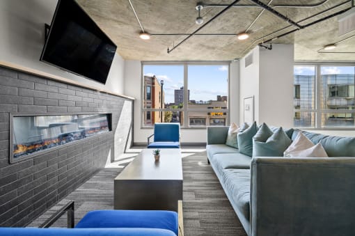 a living room with a fireplace and a large window at Lakeview 3200 Apartments, Chicago, Illinois