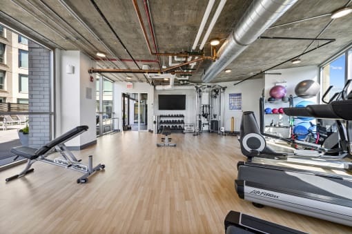a workout room with treadmills and other exercise equipment at Lakeview 3200 Apartments, Chicago