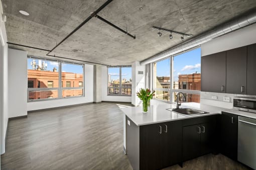 a kitchen with a large window and a view of a city at Lakeview 3200 Apartments, Chicago
