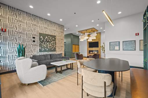 A modern living room with a patterned wallpaper and a variety of seating options.