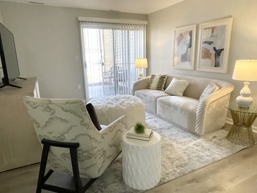 a living room with white furniture and a rug at Evergreen Luxury Apartments, Merrillville, 46410