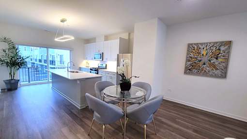 a kitchen and dining area with a glass table and chairs