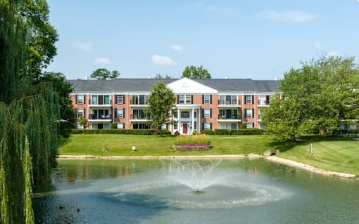 A building with a fountain in front of it at Versailles on the Lakes Oakbrook*, Illinois