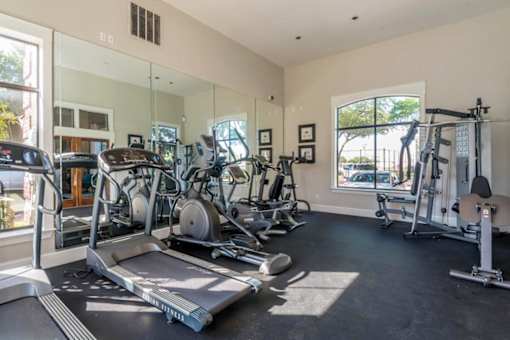 A spacious apartment gym with treadmills, exercise bikes, and other equipment at 1601 Eastchase Pkwy in Fort Worth, TX.