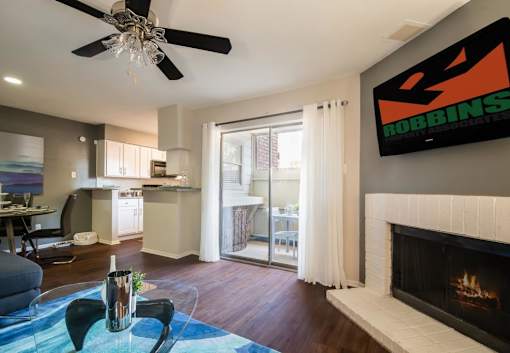 An apartment living room with a fireplace and a TV mounted on the wall at 1601 Eastchase Pkwy in Fort Worth, TX.