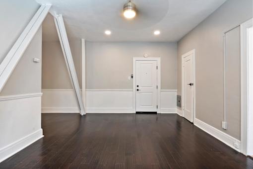 A studio apartment in Pasadena with a white door and a closet at Brookmore Apartments..
