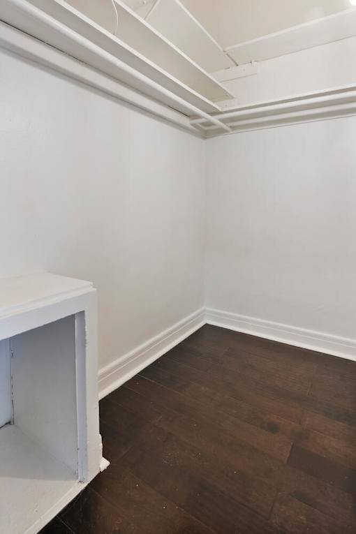 A room with a white wall and a white shelf.