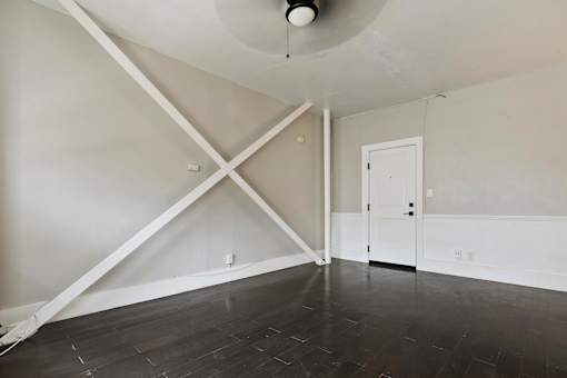 A studio apartment in Pasadena with a white door and a white ceiling fan.