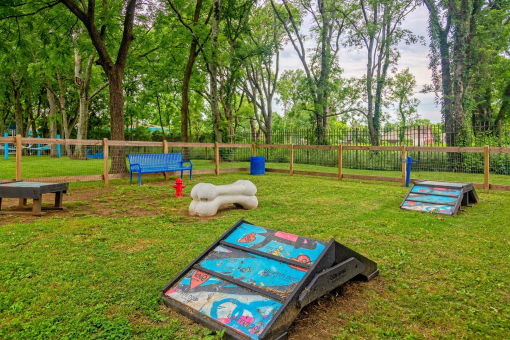 Apartments Nashville TN - The Canvas - Gated Bark Park with Obstacle Equipment, Bench Seating, and Lush Grass