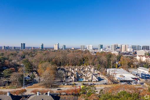 A cityscape with buildings and trees in the foreground at Fusion Buckhead Atlanta.