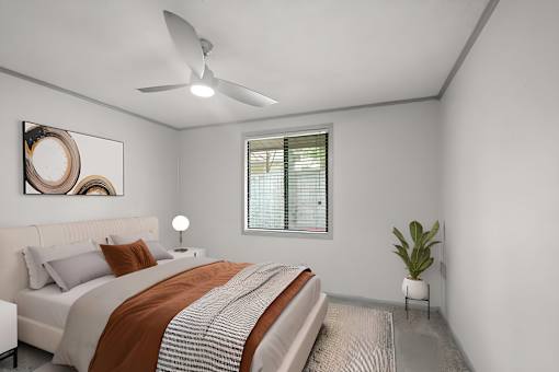 Retreat at Indian Lake Hendersonville TN apartments bedroom with a bed, a ceiling fan, and a plant.
