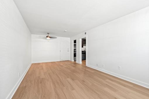 The Canvas Nashville living room with a ceiling fan and wooden flooring.