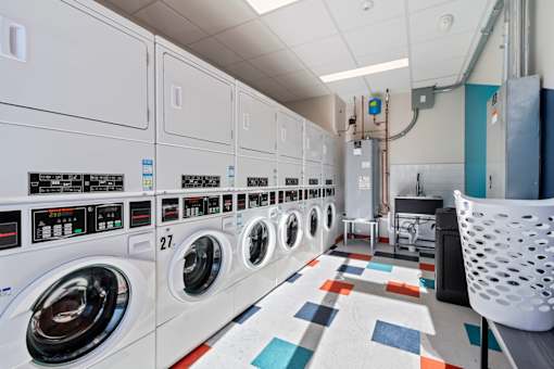 The Canvas Apartments in Nashville with laundry facility - row of washing machines are lined up.