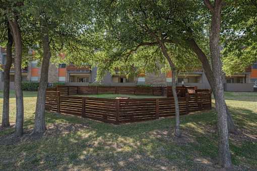 Fusion 35 pet park with a wooden fence in the foreground of a grassy area.