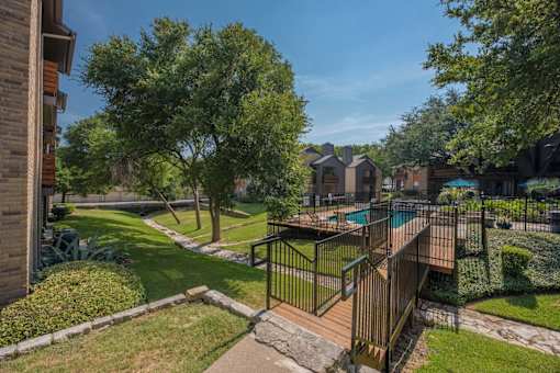 Fusion 35 gated pool surrounded by grass and trees.