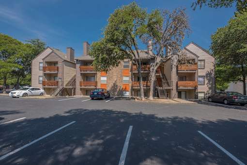 Fusion 35 parking lot with cars and apartment buildings in the background.