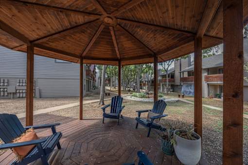 Fusion 35 wooden gazebo with a circular brick patio and four chairs.