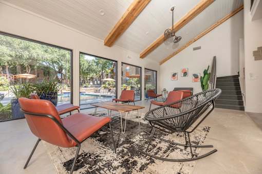 Fusion 35 clubhouse with a red chair and a black and white rug.