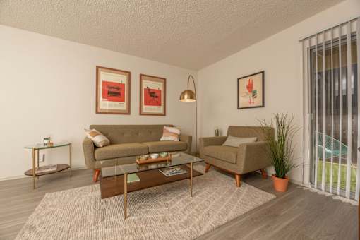 Fusion 35 living room with a couch, chair, and pictures on the wall.