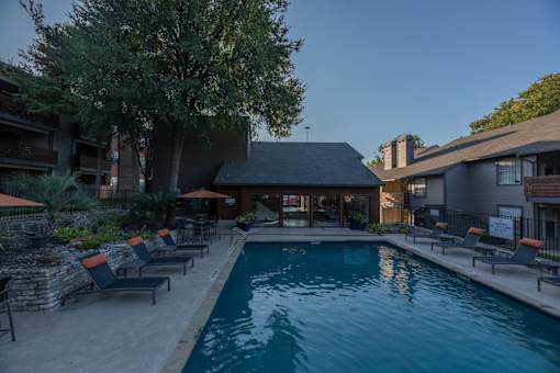 Fusion 35 pool surrounded by lounge chairs and umbrellas.