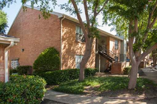 A tree in front of a brick building at 1601 Eastchase Pkwy in Fort Worth, TX.