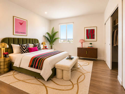 A bedroom with a green headboard and a white bed.
