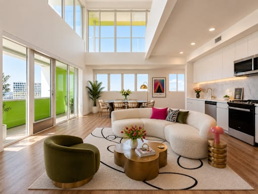 A modern living room with a green armchair and a white sofa.