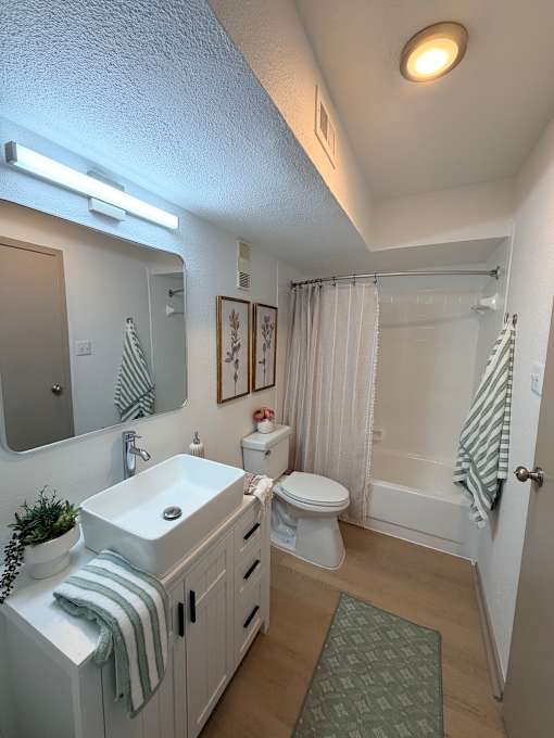 Fusion Crossroads bathroom with a white sink and toilet.
