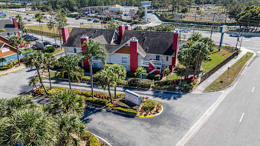 A red and white building with a flag on it at Fusion Orlando.