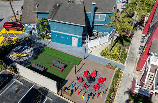 A red and black object is in the middle of a green area at Fusion Orlando.