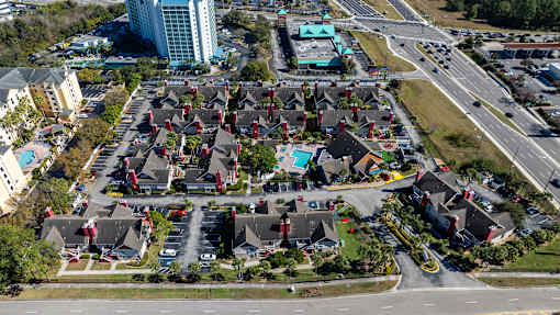 A bird's eye view of a residential area with houses and a road.