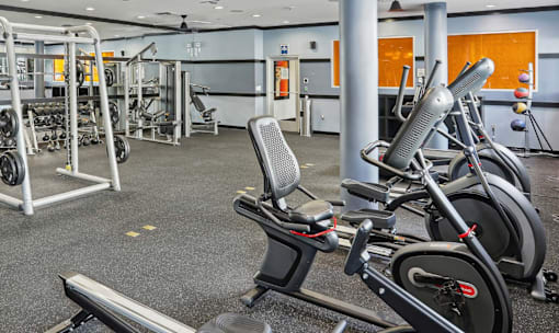 Fusion Encore Hollywood fitness center with a row of exercise bikes and weightlifting equipment.