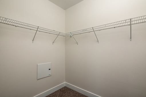 Fusion Encore Hollywood Apartments walk-in closet with a metal rack on it.