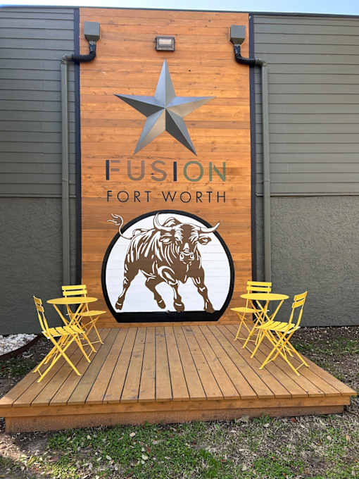 Fusion Fort Worth mural wall with wooden board with a star and a bull on it.