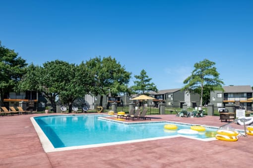 Fusion Fort Worth (previously Desert Sands) community swimming pool with large pool deck and yellow inflatables