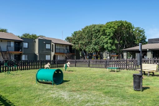Large dog park at Fusion Fort Worth apartment complex in Haltom City, TX with grey picket fence and green lawn