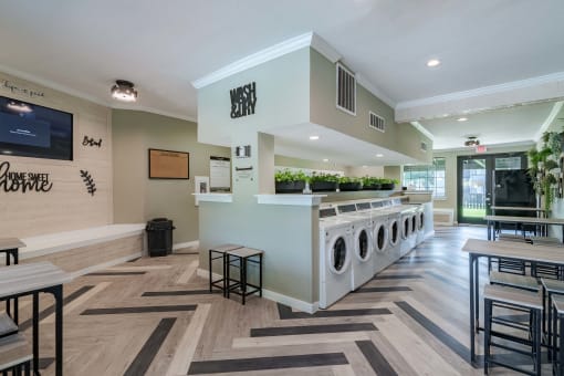fusion fort worth laundry room with many laundry machines and large waiting area
