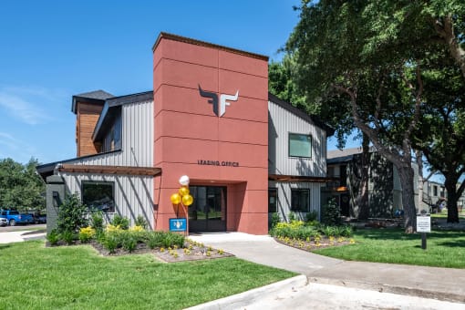 Fusion Fort Worth, new apartments in Fort Worth leasing office in Haltom City, Texas with green lawn and modern logo