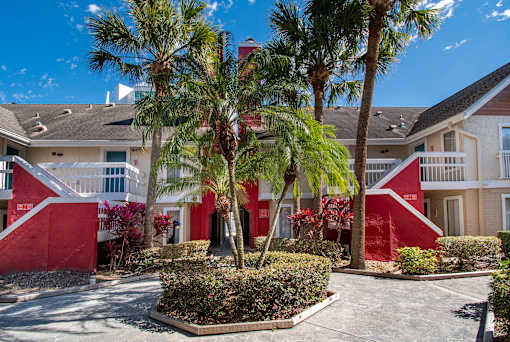 A red building with a palm tree in front at Fusion Orlando.