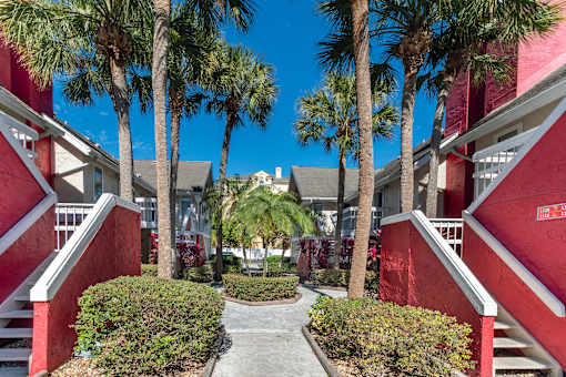 A red building with palm trees in front at Fusion Orlando.