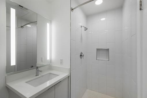 Fusion Hollywood white bathroom with a sink and a shower.