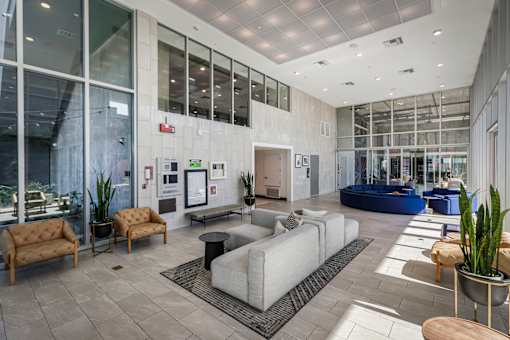 Fusion Hollywood lobby with a variety of seating options and a large glass wall.