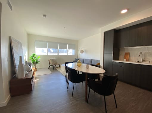 Fusion Hollywood (Alta Ink) Apartments dining room with a table and chairs.