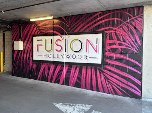 A wall with a mural that says Fusion Hollywood at Fusion Hollywood, luxury apartments in Hollywood, CA.
